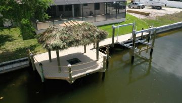 New Construction Dock with a tiki hut, boat lift, and transparent floor.