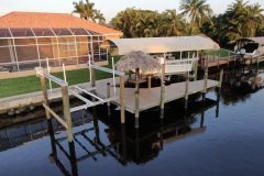 New Construction Dock with two (2) boat lifts, tiki hut, and a wrap around
