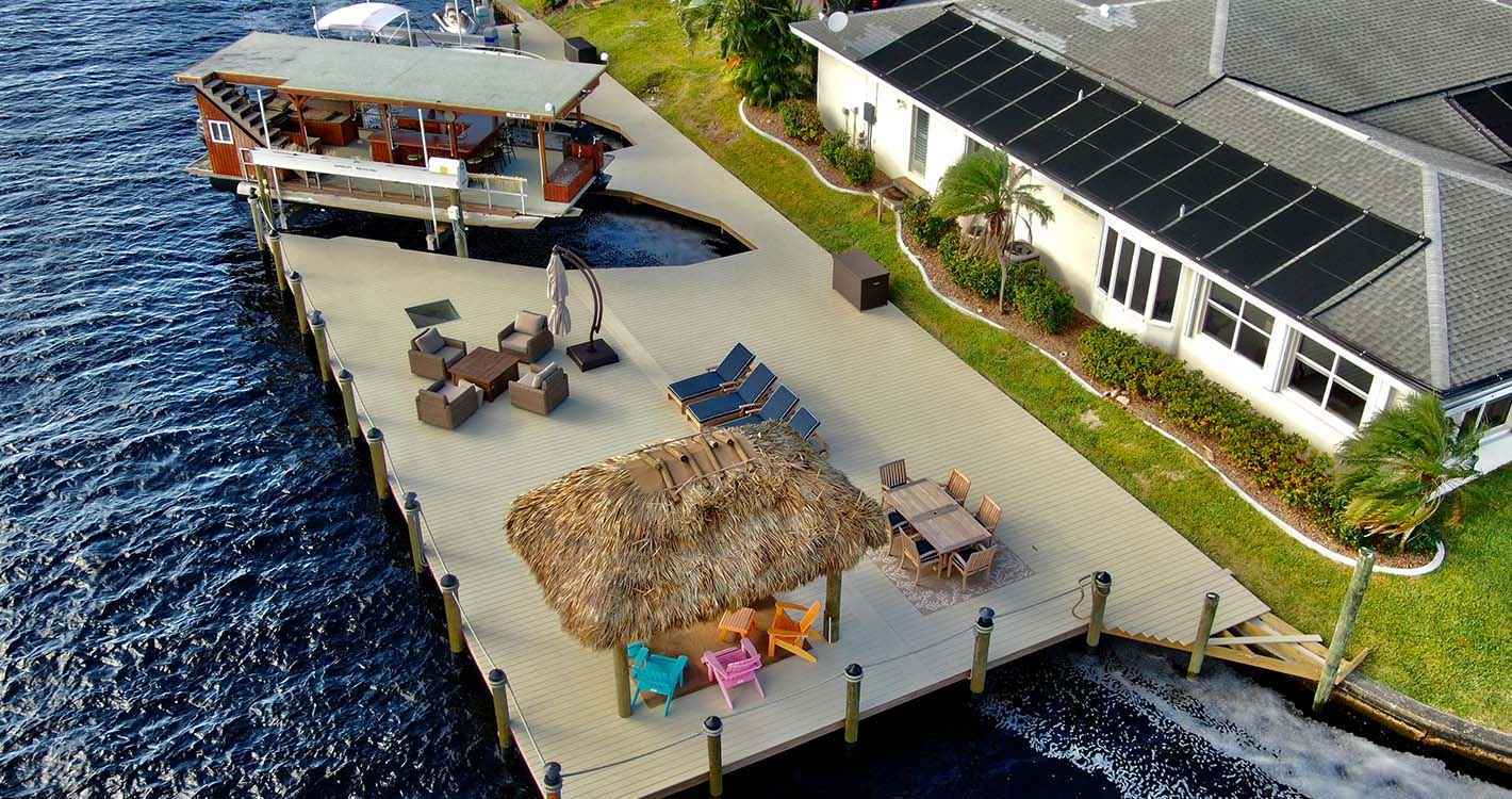 Custom dock build off of Everest parkway in Cape Coral Florida featuring boat lift and tiki hut
