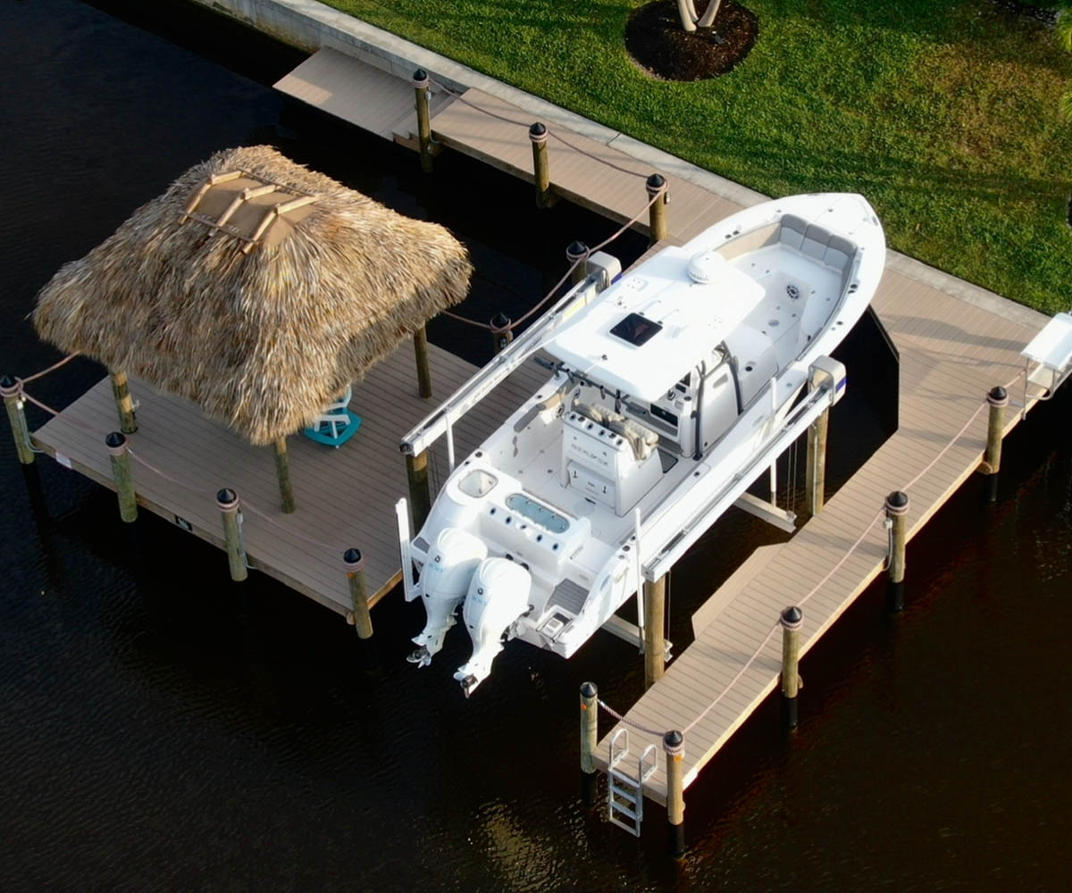custom dock and boat lift with tiki hut