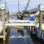 Crane setting lift piles during a boat lift installation in Cape Coral