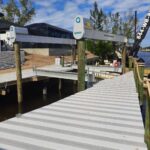 New dock addition built flush with the seawall cap beside an IMM lift in Cape Coral