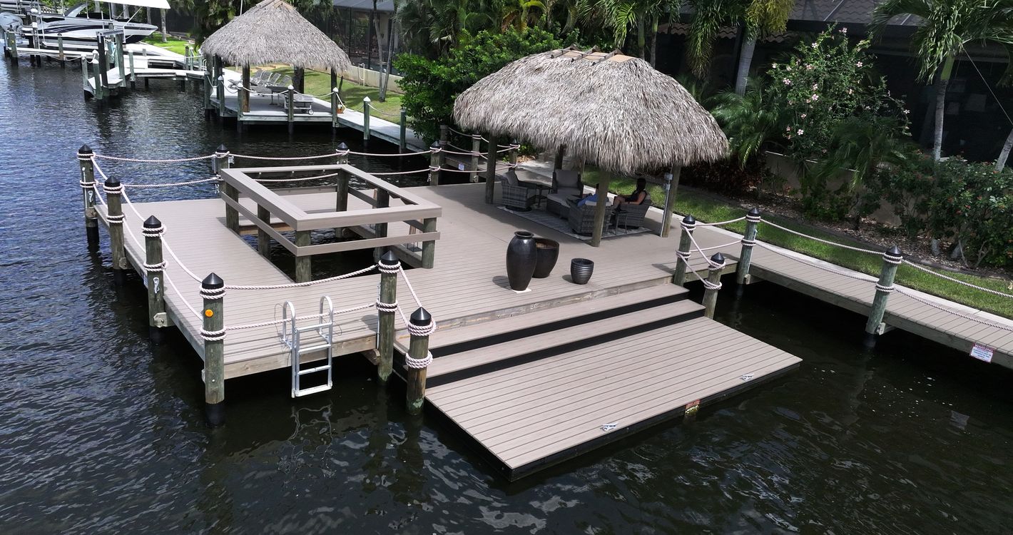 Custom Cape Coral dock with a tiki hut, viewing cutout, and lower paddle craft launch