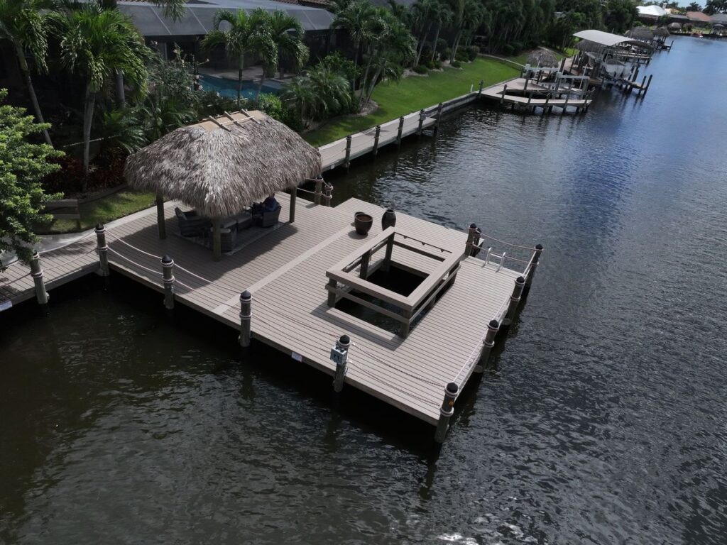 WearDeck dock with railed viewing cutout and tiki hut on a Cape Coral canal