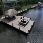 WearDeck dock with railed viewing cutout and tiki hut on a Cape Coral canal