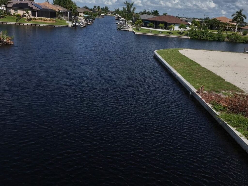 New seawall wrapping a corner lot on a northwest Cape Coral canal