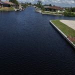 New seawall wrapping a corner lot on a northwest Cape Coral canal