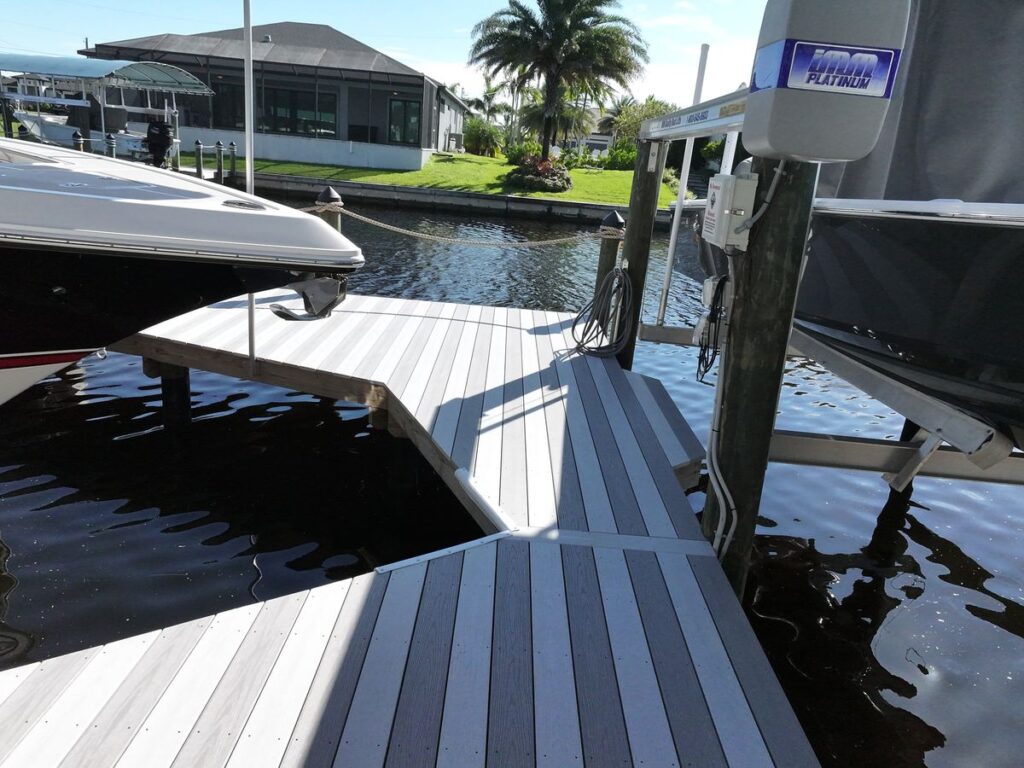 Two-tone decking pattern on a new dock next to a high speed boat lift in Cape Coral