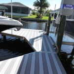 Two-tone decking pattern on a new dock next to a high speed boat lift in Cape Coral