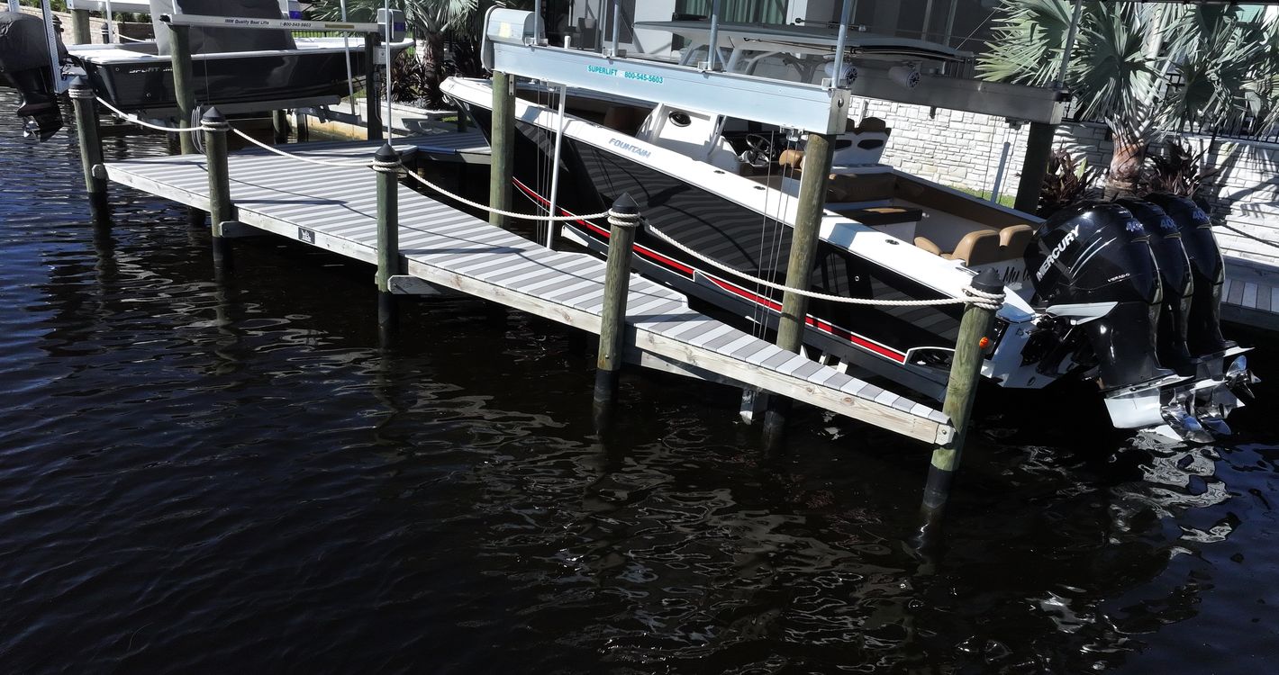 Two-tone WearDeck dock with two IMM boat lifts in northwest Cape Coral