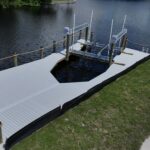 WearDeck dock with a bow-shaped boat slip and 27,000 lb IMM lift in northwest Cape Coral
