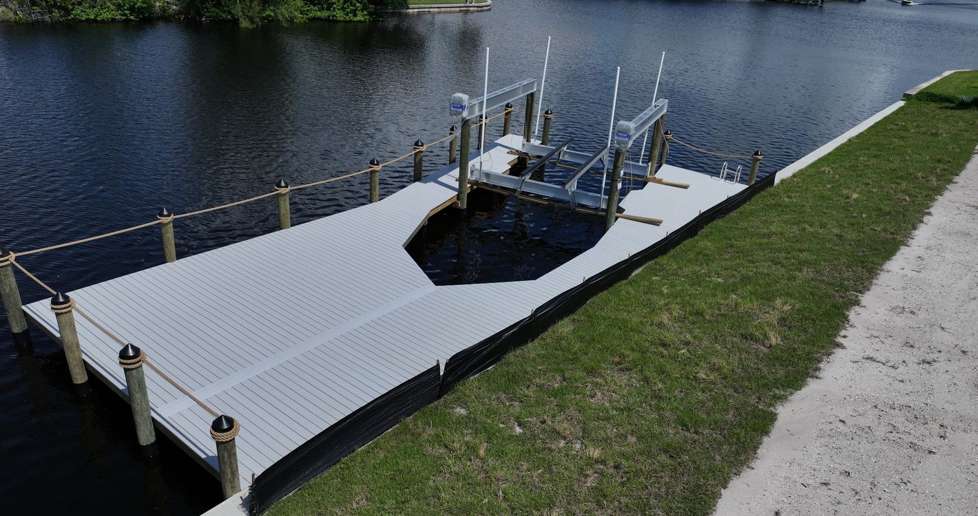 WearDeck dock with a bow-shaped boat slip and 27,000 lb IMM lift in northwest Cape Coral