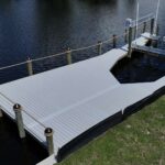 Bow-shaped boat slip and lift inside a new WearDeck dock in northwest Cape Coral