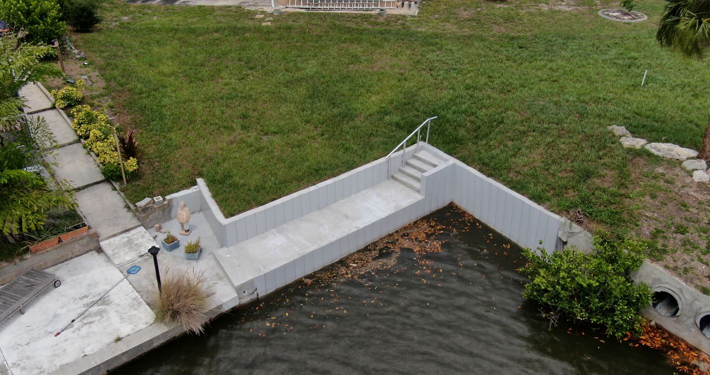 New Truline seawall with concrete deck and stairs at the end of a canal in Englewood, Sarasota County