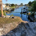 Storm washout and collapsed bank behind the old seawall in Englewood before replacement