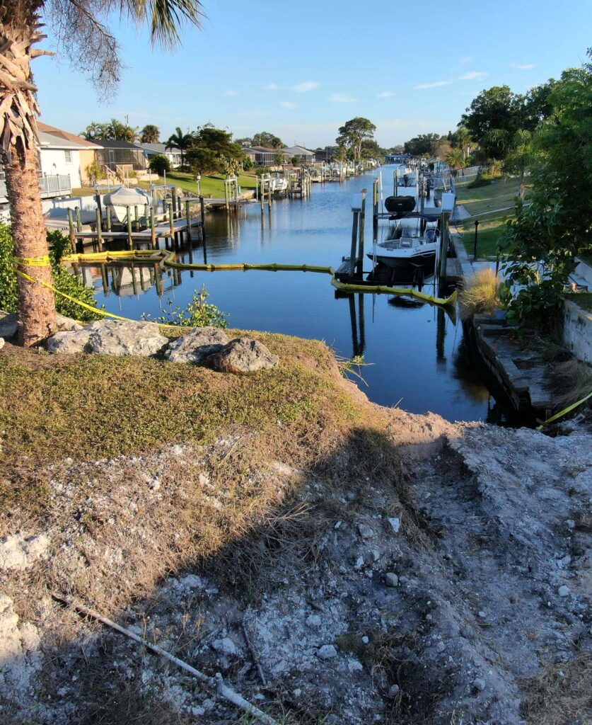 Storm washout and collapsed bank behind the old seawall in Englewood before replacement