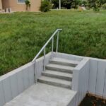 Finished Truline seawall with concrete stairs and aluminum handrail in Englewood