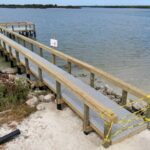 New pier walkway with timber railings under construction at Menard-May Park