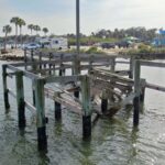 Leaning pilings and broken framing on the old Menard-May Park pier