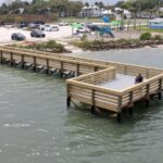 Aerial view of the Menard-May Park pier and shoreline sidewalk in Edgewater