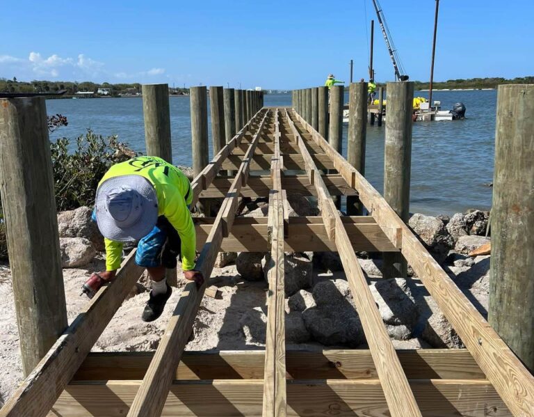 Crew framing the new Menard-May Park pier walkway over the rock shoreline in Edgewater