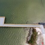 Overhead view of the finished Menard-May Park pier extending past the rock revetment
