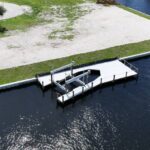Aerial view of a new seawall and dock on a northwest Cape Coral corner lot