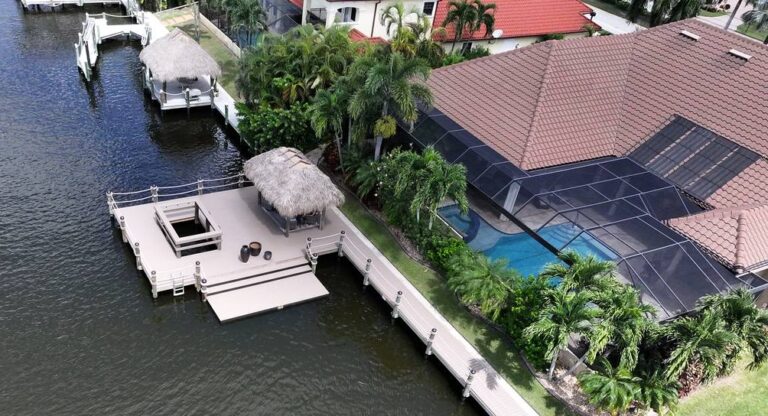 Aerial view of a new dock with tiki hut behind a pool home in southwest Cape Coral